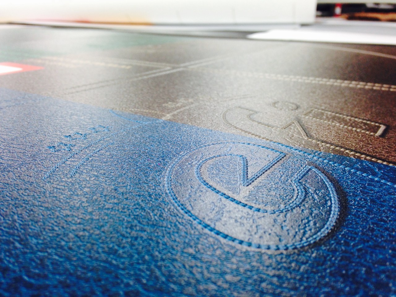 Table top printed with a simulated leather texture with EFI logo.